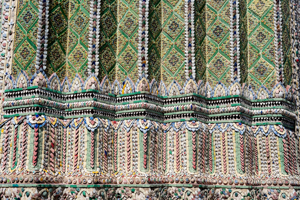 The image showcases a close-up view of a ornate building adorned with intricate patterns and designs, showcasing the intricate craftsmanship and attention to detail.