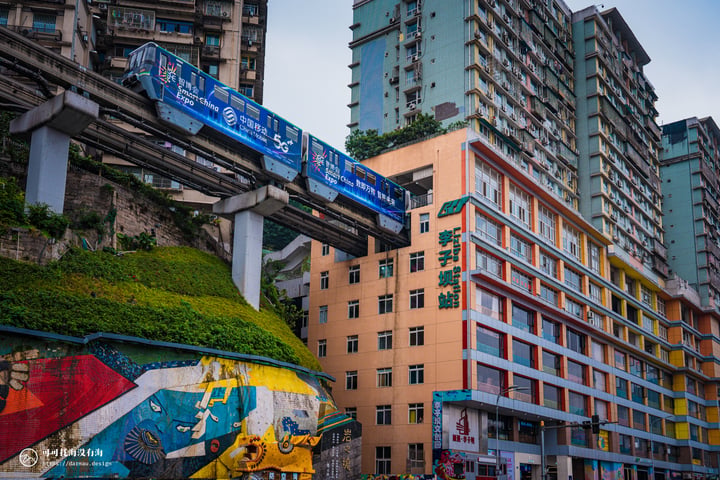 A bustling Chongqing street scene features a colorful train track, a colorful building, a statue of a lion, and a pedestrian crossing.