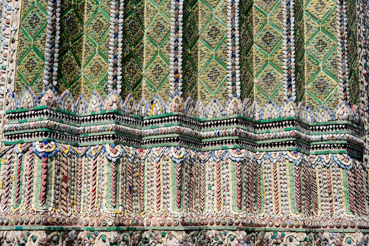 The image showcases a close-up view of a ornate building adorned with intricate patterns and designs, showcasing the intricate craftsmanship and attention to detail.